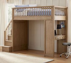 a wooden bunk bed sitting next to a desk