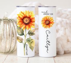 two sunflowers painted on the side of white cans