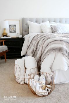 a bed with white pillows and blankets in a bedroom