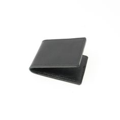 Black leather bifold credit card holder with six individual card slots. This simple card holder is made from a combination of leathers.  The outer piece is a 2mm thick black leather with a slightly textured finish.  The inner pockets are made from a thinner complimentary leather.  The card wallet is entirely hand-stitched using traditional saddle stitch and linen thread.  Edges are burnished to give a smooth finish.  Credit card holders measure approximately 213mm x 77mm opened out; or 100mm x 7 Formal Leather Card Holder With Id Window, Formal Bifold Card Holder With Rfid Blocking, Leather Card Holder With Id Window For Formal Use, Black Leather Trifold Wallet For Business, Black Bifold Card Holder For Business, Black Trifold Card Holder With Interior Slots, Classic Rfid Blocking Card Holder For Business, Classic Trifold Card Holder With Id Window, Classic Black Card Holder For Daily Use