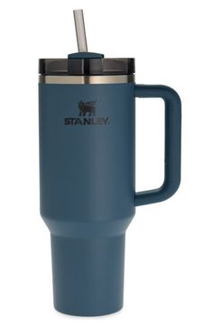 the stanley travel mug is blue and has a straw in it's cup holder