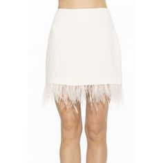 a woman is wearing a white skirt with feathers on the bottom and side, while standing in front of a white background