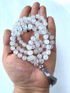 Hare Krishna ✅With the Brand Name of HANDCRAFTS CREATIONS✅ 🌱Beautiful Natural 8mm Moonstones Japa mala | Necklace | Prayer Beads Mala🌱 Available in Two-color tassel: 1. White  2. Grey ❣️You never see this unbreakable quality of closing knots.  ✅This beautiful Moonstone Beads mala is hand-knotted on a bright & Shine Grey Colour thread to add longevity and comfort during meditation and finished with a Shining German SIlver guru bead and a matching Contrast Grey Colour silk tassel.✅ 🌺108 Beautiful Moonstones 🌿8mm Hand-knotted Japa Mala with Stylish Knotted Finishing with Wax/Parachute Thread to add longevity & comfort during meditation with Unbreakable Quality. Finished With ❤️ German Silver Guru Bead❤️ and with a new finishing, closing knots design. Best product to give someone as a spir Adjustable White Gemstone Beads Mala, White Adjustable Mala With Gemstone Beads, Adjustable White Mala With Gemstone Beads, Adjustable White Mala With 8mm Beads, White 8mm Bohemian Beads, White Round Spiritual Beaded Necklaces, Spiritual White Round Beaded Necklaces, White Round Beaded Spiritual Necklace, White Round Spiritual Beaded Necklace