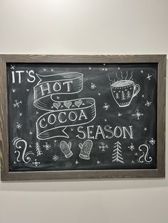 a chalkboard sign that says it's hot cocoa season and winter themed items