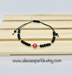 The post is for one individual bracelet. This beautifully handmade bracelet is made of 4mm black rondelle crystal beads, small gold beads with a turkish glass eye bead that is 6mm. They are made with red nylon string and are adjustable to fit most wrists as it has a sliding knot to adjust. These are a great accessory for everyday wear. This bracelet is great for spiritual and evil eye purposes. It is believed that when a person wears or carries an evil eye with them, it guards against misfortune Spiritual Evil Eye Bracelet With Round Beads, Adjustable Rondelle Crystal Bracelet With 8mm Beads, Adjustable Evil Eye Bracelet, Black Evil Eye Bracelet With Round Beads As Gift, Adjustable Crystal Bracelet With Black Beads As Gift, Spiritual Resizable Evil Eye Bracelet With Round Beads, Black Adjustable Rondelle Beaded Bracelets, Adjustable Evil Eye Bracelet With 8mm Beads, Black Crystal Bracelet With Spacer Beads For Gift