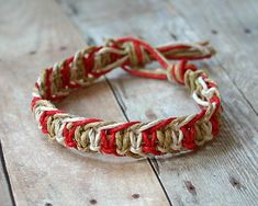 a close up of a bracelet on a wooden surface