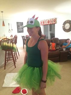 a woman in a green costume standing on the floor