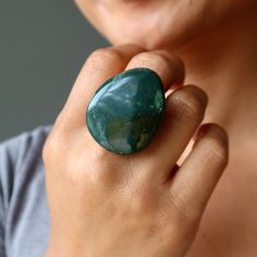 When you wear this beautiful green Bloodstone ring, you feel like the Captain of Courage. The big, bold gemstone accentuates your strengths and sharpens your decision-making skills. You are the master of your destiny. Positive Affirmation: "Call me Captain Courage" Primary Chakra: Heart Chakra Intentions: Abundance Crystals STYLE DESCRIPTION Your new ring features an authentic Bloodstone stone. This is a deep green stone with red inclusions. May show purples and whites. The stone is polished int Abundance Crystals, Bloodstone Ring, 11 Stone, Decision Making Skills, Bronze Ring, Big Rings, Green Gems, Positive Affirmation, Chakra Crystals