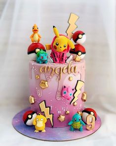 a pokemon themed birthday cake with pikachu and other figurines on top