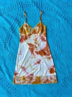 Expertly hand dyed nylon vintage slip dress. Layer this look over a turtle neck in the winter or over a swimsuit by the pool, they're great on their own too! This vintage slip has been carefully tie dyed to disguise stains and discoloration. Originally white, it has a unique all over tie dye pattern in deep orange. Can be washed on cold with like colors. This is a one of one item This slip is in very good vintage condition. There are no holes or tears. The straps are adjustable. Bust: 34" Waist: Casual Fitted Slip Dress For Beach, Fitted Cotton Slip Dress For Summer, Spring Bohemian Fitted Slip Dress, Bohemian Fitted Slip Dress For Spring, Vintage Fitted Slip Dress For Summer, Hand Dyed Fitted Summer Dress, Orange Tie Dye, Vintage Slip Dress, Dress Layer