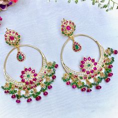 Chandbali earrings in sterling silver with 22K gold plating. It has been set with freshwater pearls and synthetic rubies and emeralds. The hanging beads are real rubies and emeralds of very good color and clarity. Weight 31 GMs Dimensions : 2.5 x 1.75 inches Traditional Pearl Drop Hoop Earrings For Celebrations, Traditional Emerald Earrings For Festive Season, Traditional Festive Emerald Earrings, Festive Emerald Earrings, Green 22k Gold Chandbali Earrings, 22k Gold Green Chandbali Earrings, Traditional Hoop Earrings With Pearl Drop, Traditional Jeweled Pearl Earrings For Celebration, Festive Temple Jewelry Emerald Earrings