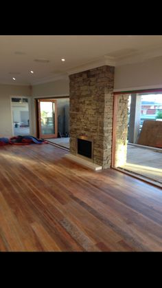 an empty living room with hard wood flooring