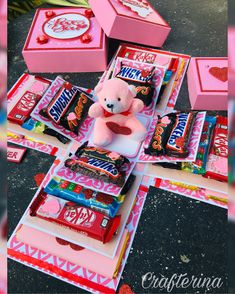 a teddy bear sitting on top of a table filled with candy