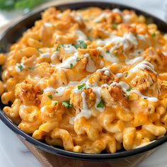 a bowl filled with macaroni and cheese covered in sauce