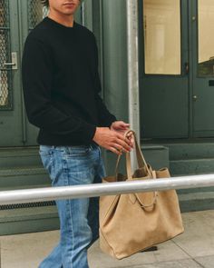 The E42 is the ideal bag for the man on the go. Taking you easily from the office, to the gym, to a weekend away, the E42 makes a perfect travel companion. The style is kept unlined for a more casual and lightweight feel, and hardware is minimal to retain a sleek, easygoing feel. Available in warm Acorn, fresh Ivory, or classic Black tumbled-grain leather. Casual Duffle Bag With Leather Handles For On-the-go, Everyday Tote Duffle Bag With Leather Handles, Casual Weekender Bag With Removable Pouch For Everyday Use, Casual Satchel With Leather Handles For Everyday, Casual Leather Weekender Bag With Top Carry Handle, Casual Everyday Satchel With Leather Handles, Casual Satchel Tote With Luggage Sleeve, Casual Everyday Bag With Luggage Sleeve, Modern Everyday Satchel With Dust Bag