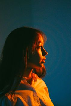 a woman with long hair is looking off into the distance