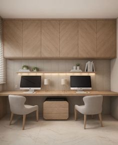 two computer monitors sitting on top of a wooden desk