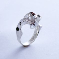 A simple band blooms into an intricate convolution of sterling silver. This ring is 3D printed in wax, then cast in silver using lost wax casting. Also available in brass, 14k gold, 18k gold, palladium, and platinum by special order. Our Florescence collection is inspired by the biomechanics of growing leaves and blooming flowers. Each piece emerges from a computational simulation of differential growth, a surface that grows at different rates in different location. The flowering structures expa Modernist Sterling Silver Wedding Rings, Hand Forged Sterling Silver Signet Ring, Elegant Sterling Silver Hand Forged Signet Ring, Elegant Hand Forged Sterling Silver Signet Ring, Formal Hand Cast Sterling Silver Rings, Modernist Hand Cast Jewelry As Gift, Hand Cast Modernist Jewelry For Gifts, Elegant Hand Cast Signet Ring Gift, Unique Hand Cast Signet Ring For Anniversary