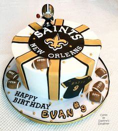 a new orleans saints birthday cake with footballs on it