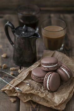 three chocolate macaroons and two cups of coffee