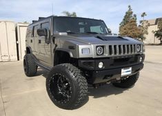 a gray hummer truck parked in a parking lot