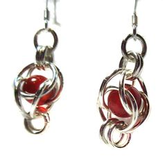 Beautiful genuine Red Coral beads float freely in their .925 Sterling Silver baskets.  These lovely earrings have a drop of approximately 1.5 inches.  They have .925 Sterling Silver French ear wires, our favorite type of earring closure. These beautiful earrings pair beautifully with our genuine coral basket bracelet. These stylish for the workplace or out for an evening.  Blends well with your Southwestern jewelry such as turquoise and ebony or jade. Red Sterling Silver Drop Earrings, Red Dangle Earrings With Ear Wire, Hypoallergenic Red Metal Jewelry, Red Wire Wrapped Metal Jewelry, Red Sterling Silver Earrings For Pierced Ears, Red Teardrop Sterling Silver Jewelry, Red Sterling Silver Pierced Earrings, Red Wire Wrapped Earrings, Red Round Jewelry With Silver Beads