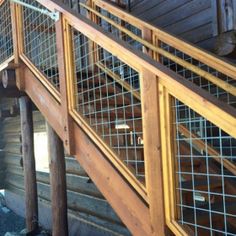 the stairs are made out of wood and metal mesh railings, along with wooden posts