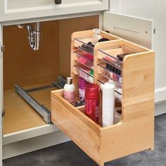 an open drawer in a kitchen filled with beauty products