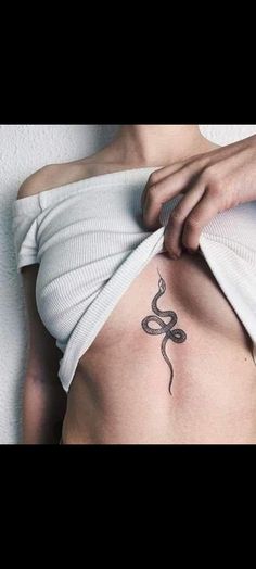 a woman with a snake tattoo on her stomach