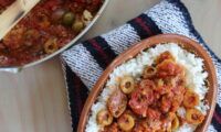 two bowls filled with food on top of a table