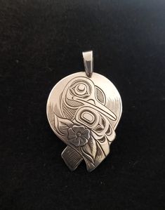 On offer is a made to order West Coast Namgis First Nation Hand Carved silver ''Hummingbird''  round  antiqued patina look pendant. Polished pendant also available by World renowned master carver Joe R. Wilson with his depiction of Hummingbird in the style of the Namgis, Kwakiutl First Nation. Initialed by Joe. Fine example of Indigenous Art from the Northwest Coast First Nations of Canada. If you want to see more of my items, google ( The Kanata Shop ) PLEASE NOTE THAT THIS IS A CUSTOM RECREATE Unique Bird Design Pendant Jewelry, Silver Bird Pendant Jewelry, Silver Jewelry With Bird Design, Sterling Silver Bird Pendant Jewelry, Unique Silver Jewelry With Bird Design, Winter Ceremony, Hummingbird Pendant, Northwest Coast, Indigenous Art