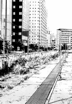 a black and white photo of a city street with tall buildings in the back ground