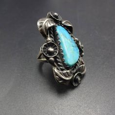 ". VINTAGE TAXCO RING DESCRIPTION: This gorgeous ring features a stunning specimen of turquoise. The gemstone is secure in scalloped bezel, on a foundation of heavy gauge vintage sterling silver. Applied leaves and twisted silver frame the lovely cabochon. This ring will be a treasured addition to your collection of fine vintage jewelry. MEASUREMENTS: Ring face measures 1 1/2\" x 1\" Cabochon measures 19mm x 9mm RING SIZE: 6 WEIGHT: 12.2 grams SIGNED: yes STERLING: yes, stamped STERLING" Vintage Adjustable Turquoise Cabochon Ring, Collectible Silver Turquoise Cabochon Ring, Elegant Multi-stone Turquoise Ring In Sterling Silver, Turquoise Men, Sterling Silver Multi-stone Turquoise Ring Gift, Sterling Silver Rings Turquoise, Turquoise Ring Silver, Adjustable Southwestern Turquoise Ring Nickel-free, American Jewelry