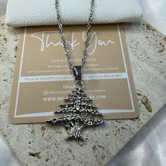 Elevate Your Style with ReluumJewellery's Country Map Pendant Necklaces: Introducing our Lebanese Cedar Tree Pendant Necklace - a proud symbol of resilience and heritage. Crafted with intricate detail, this necklace features the iconic Lebanese Cedar Tree, representing strength and endurance in Lebanese culture. Whether you're honoring your roots or drawn to its symbolism, this pendant is a perfect statement piece. 🌍 Embrace the world in style with ReluumJewellery's Country Map Pendant Necklace Valentine's Day Gift Silver Chain Necklace, Silver Clavicle Necklace For Christmas, Silver Chain Metal Charm Necklace As Gift, Silver Clavicle Chain Necklace For Christmas, Metal Pendant Necklaces For Birthday, Metal Pendant Necklace For Birthday, Silver Nickel-free Chain Necklace As Gift, Stainless Steel Chain Necklace For Gifts, Holiday Sterling Silver Necklaces