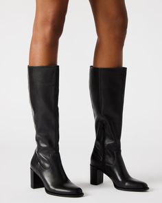 Step up your style with the JOVANA knee-high block heel boot. Crafted with a rounded toe, these boots offer both comfort and sophistication. The perfect addition to any outfit, these boots will elevate your look with their sleek design and sturdy heel. 2.75 inch heel height Size 6 measurements: 14.5 inch shaft circumference, 14.25 inch shaft height Size 8 measurements: 15.5 inch shaft circumference, 15.25 inch shaft height Size 10 measurements: 16.5 inch shaft circumference, 16.25 inch shaft hei Sleek Wide Calf Boots With Stacked Heel, Knee-high Platform Boots With Stacked Heel, Wide Calf Heeled Boots With Stacked Block Heel, Wide Calf Tall Platform Boots With Stacked Heel, Tall Platform Boots With Stacked Heel And Wide Calf, Tall Platform Boots With Stacked Heel, Sleek Block Heel Knee-high Boots For Work, Sleek Knee-high Boots With Block Heel, Wide Calf Tall Boots For Workwear