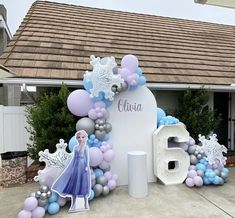 a frozen princess themed birthday party with balloons and balloon decorations on the front of a house