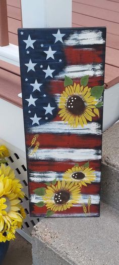 an american flag with sunflowers painted on it