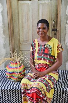 a woman sitting on top of a black and white checkered table cloth