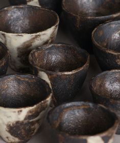 several brown and white bowls sitting next to each other