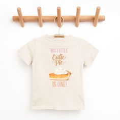 Cutie Pie Fall First Birthday shirt, Our Little Cutie Pie is Turning One shirt,  Pumpkin Pie Shirt, Pumpkin Birthday, Matching Family Shirts Welcome to Christi Creations! Here you will find that unique outfit for a special birthday! We have been in business over 14yrs here on Etsy and can assure you that you will receive 5 Star service! Thank you for supporting our small family business:) "Cutie Pie" birthday collection. Matching family members also available. If you are looking for a particular Cute Graphic Print Top For Birthdays, Casual T-shirt With Funny Print For First Birthday, Cute Short Sleeve Birthday Shirt, Graphic Tee For First Birthday With Short Sleeves, Cute Crew Neck Top For Birthday, Cute Birthday Top With Crew Neck, Cute Shirt With Graphic Print For First Birthday, Cute Graphic Print Shirt For First Birthday, Casual Pre-shrunk T-shirt For First Birthday