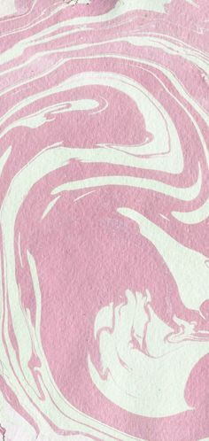 a pink and white swirl pattern on a piece of paper that has been painted with acrylic paint