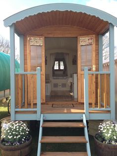 a tiny house with steps leading to the front door