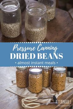 four jars filled with food sitting on top of a wooden table next to utensils