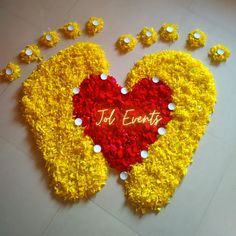 a decorated heart with the word jol events written on it in red and yellow