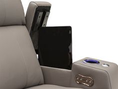 the back end of a reclining chair with an electronic device and tablet in it