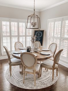 a dining room table with chairs and a chandelier