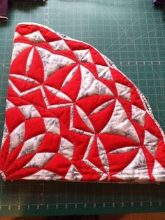 a red piece of fabric on top of a cutting board