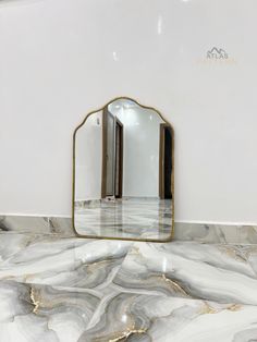 a mirror sitting on top of a marble counter