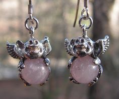 An entirely sterling silver pair of Flying Pig earrings with Rose Quartz. This original design from my studio is two smiling Pigs with 8 mm round natural Rose Quartz spheres. The Pigs dangle freely from sterling French ear wires. Each Pig measures 1/2 inch (12 mm) from top to bottom and weighs 2.2 grams. These fun and unique Piggies are also available with other stones, please inquire. Thank you Flying Pig Earrings, Smiling Pig, Pig Jewelry, Pig Earrings, Flying Pig, Quartz Sphere, Pigs, Ear Wires, Trinket Boxes