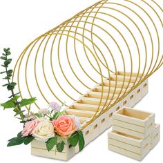 an arrangement of flowers and wooden boxes are arranged on a white background with gold spiral design